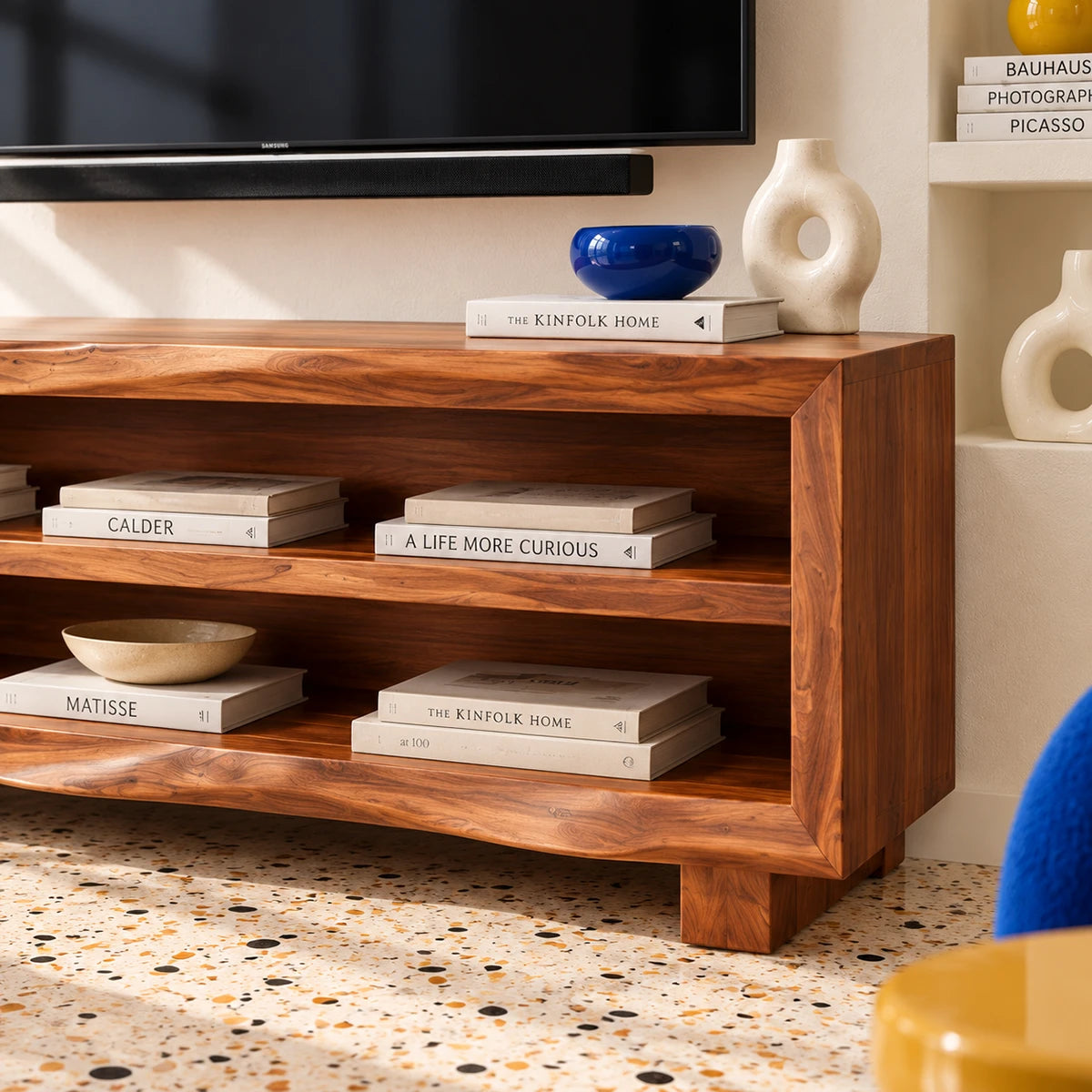 Low profile entertainment unit in natural solid wood with clean open storage space