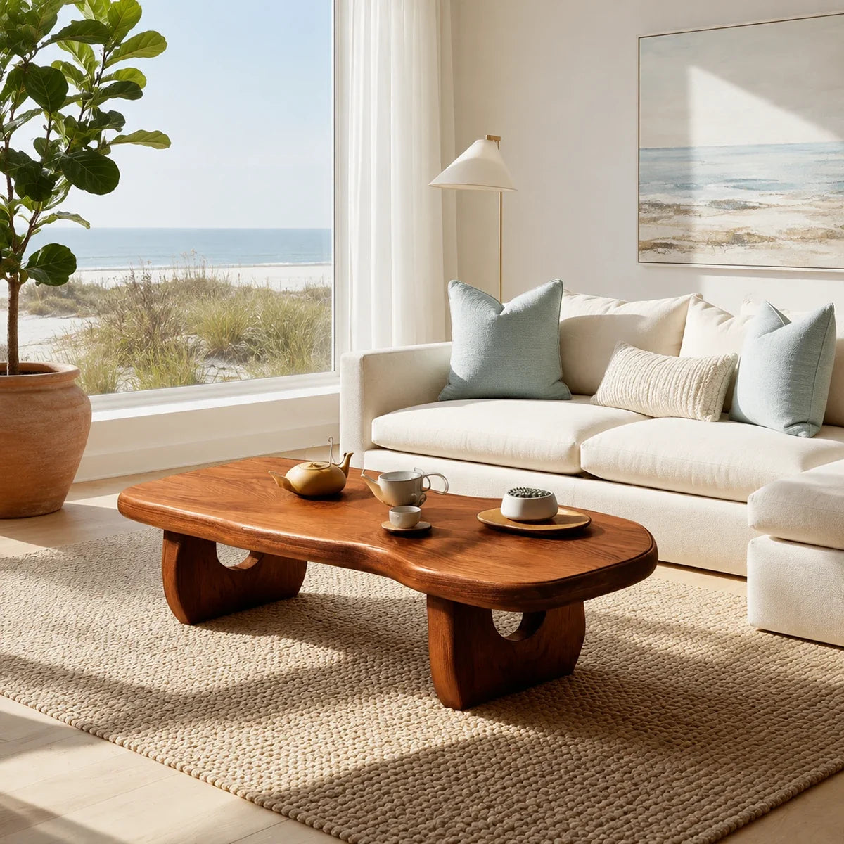 Curved coffee table adds sculptural character and practical surface to airy interiors