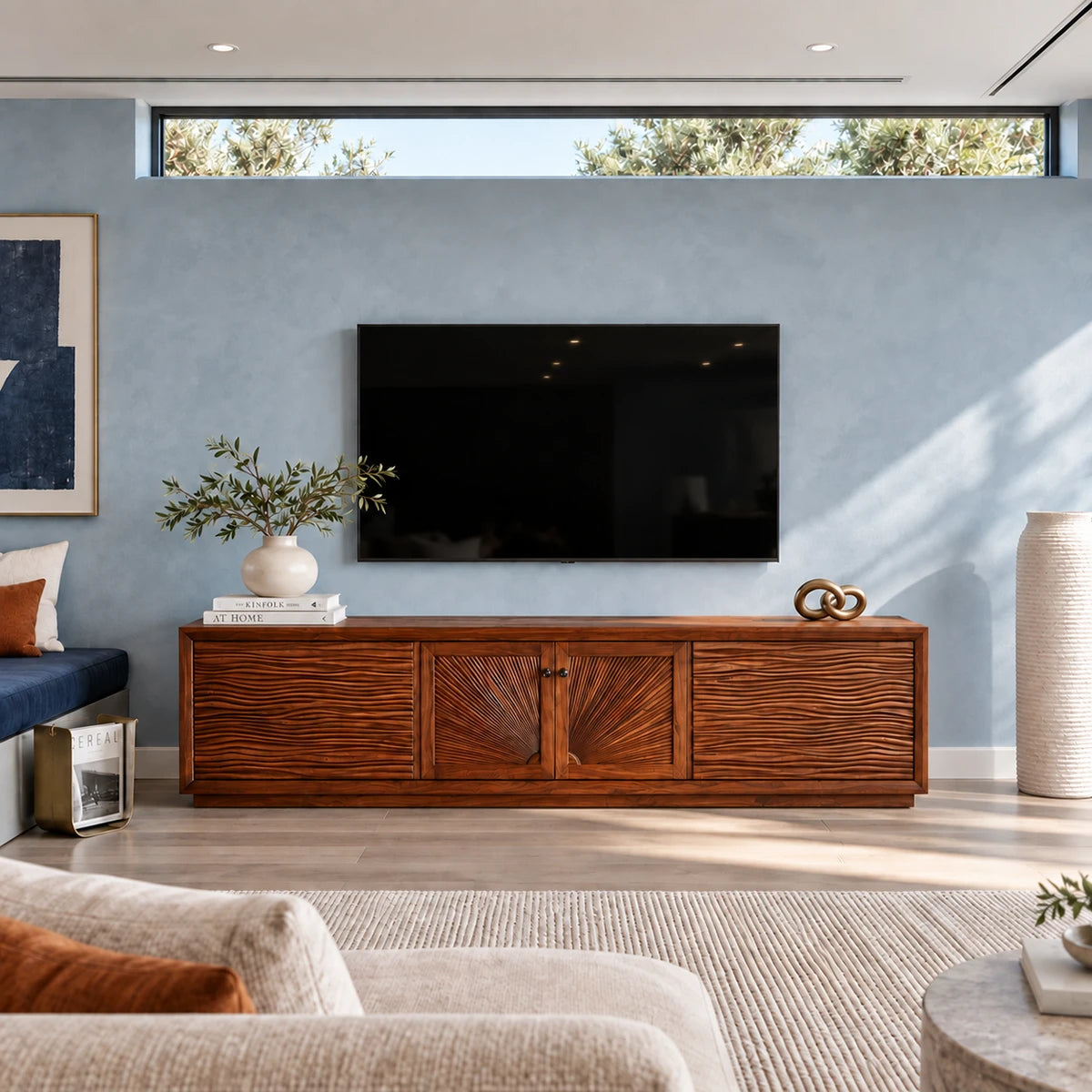 Entertainment center in solid wood with sculpted fronts and a broad low profile design