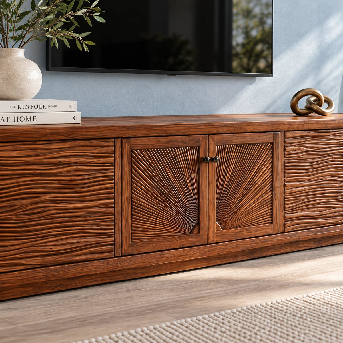 Low profile TV console in solid wood with carved side panels and center cabinet doors