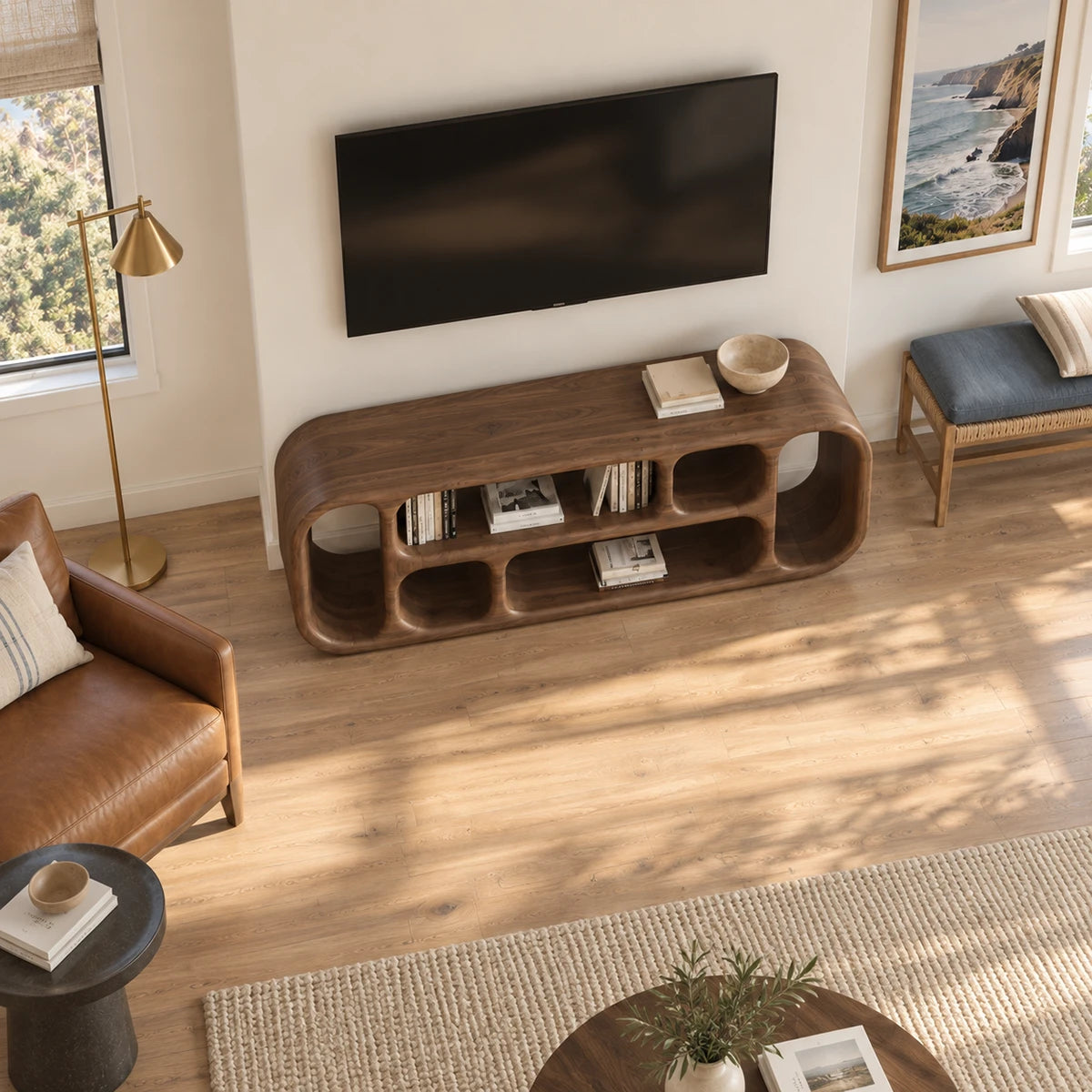 Minimalist media unit in natural solid wood with open cubbies and soft curved ends