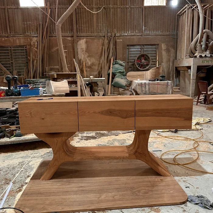 Arboriswood solid wood console table with three drawers and sculptural base in the workshop