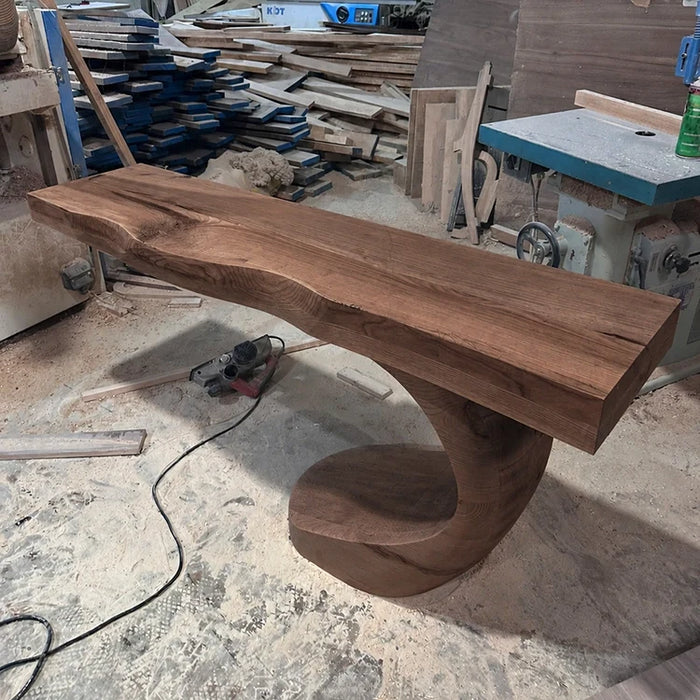 Arboriswood solid walnut console table with live-edge top and sculptural spiral base in the workshop