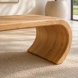 Designer bench featuring an open center and flowing solid wood curves for refined spaces