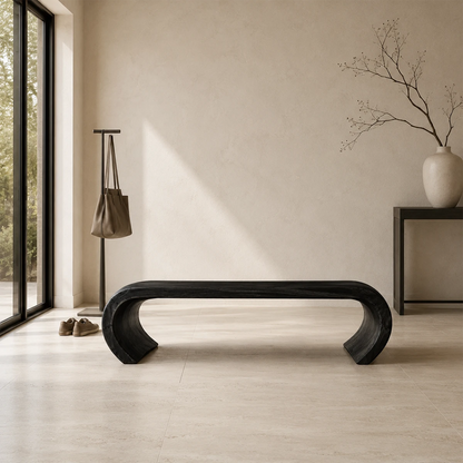 Statement bench with bold open silhouette and sculptural solid wood form for luxury homes
