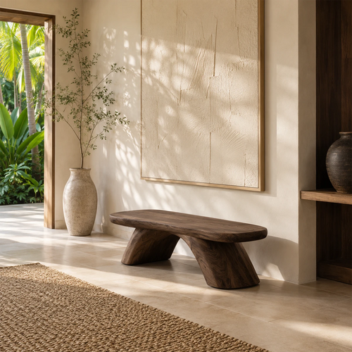 Sculptural bench with asymmetrical legs adds artistic seating to a serene entryway