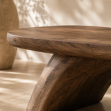 Handcrafted entry bench brings sculpted form and practical seating to a calm interior