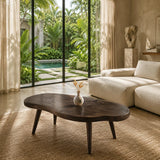 Artisan coffee table with a sculpted solid wood top and slender legs for calm interiors