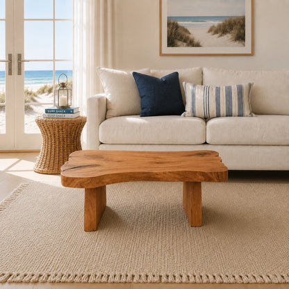 Designer coffee table with an asymmetrical top and bold handcrafted legs for casual spaces