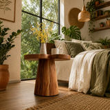 Designer bedside table with soft organic edges and visible grain in a warm natural room