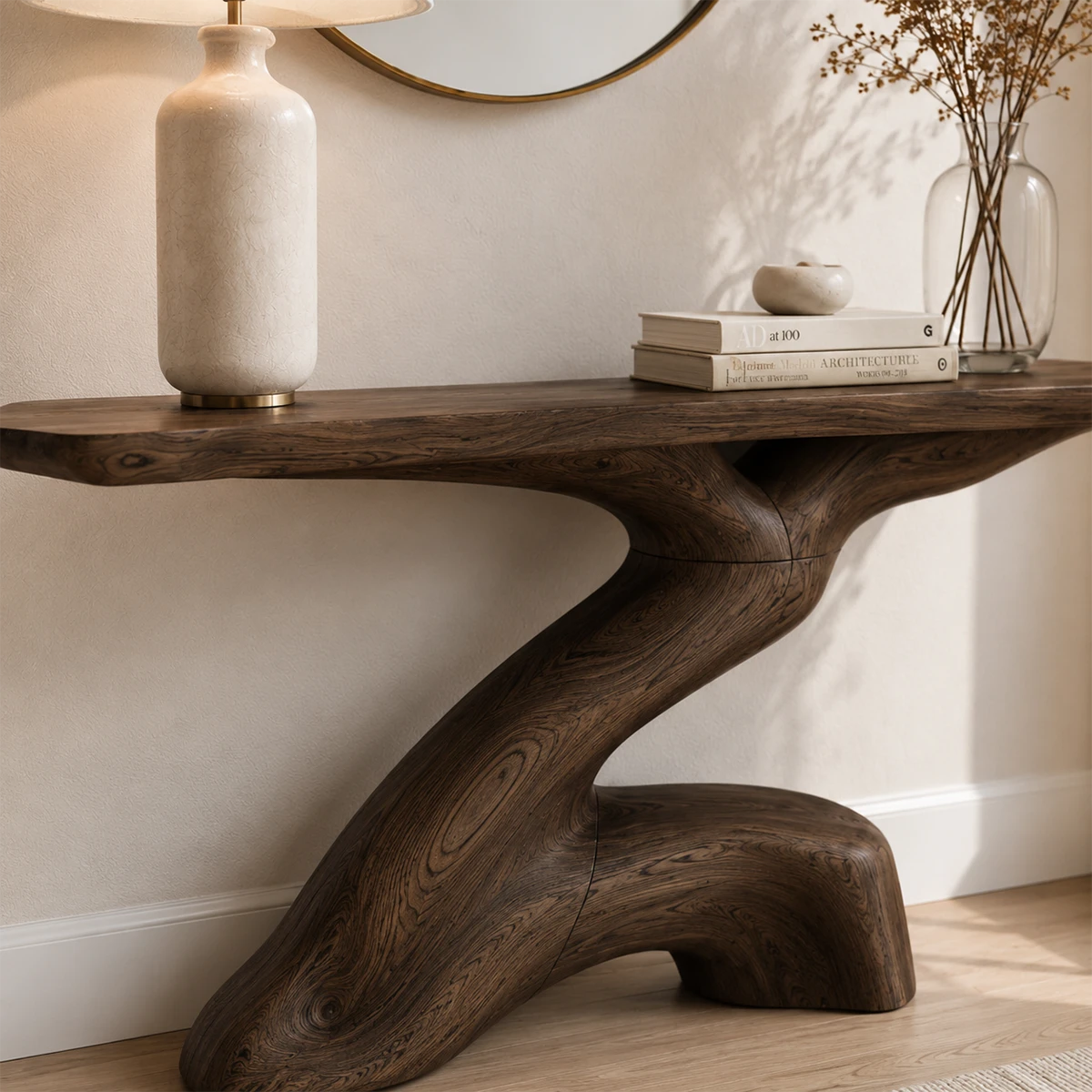 Designer hallway table with sculpted base detail and deep wood tone finish indoors