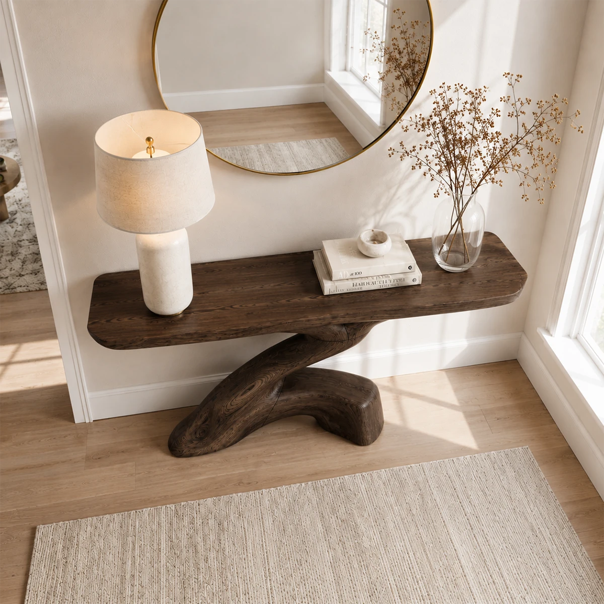 Narrow console table with an artistic pedestal form for refined foyer decor styling
