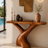 Designer hallway table with sculpted curves and visible grain in a serene home setting