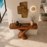 Narrow console table with artistic branch like base for refined foyer decor styling