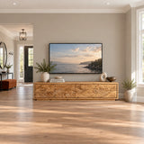 Modern solid wood TV stand with carved coastal scene and low-profile storage design
