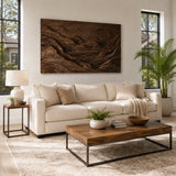 Large relief wall sculpture with mountain contours brings texture above a modern sofa