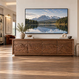 Sculptural entertainment center in solid wood with landscape carving across doors
