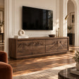 Solid wood TV stand with carved wave and mountain relief across four storage doors
