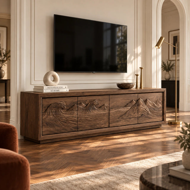 Solid wood TV stand with carved wave and mountain relief across four storage doors
