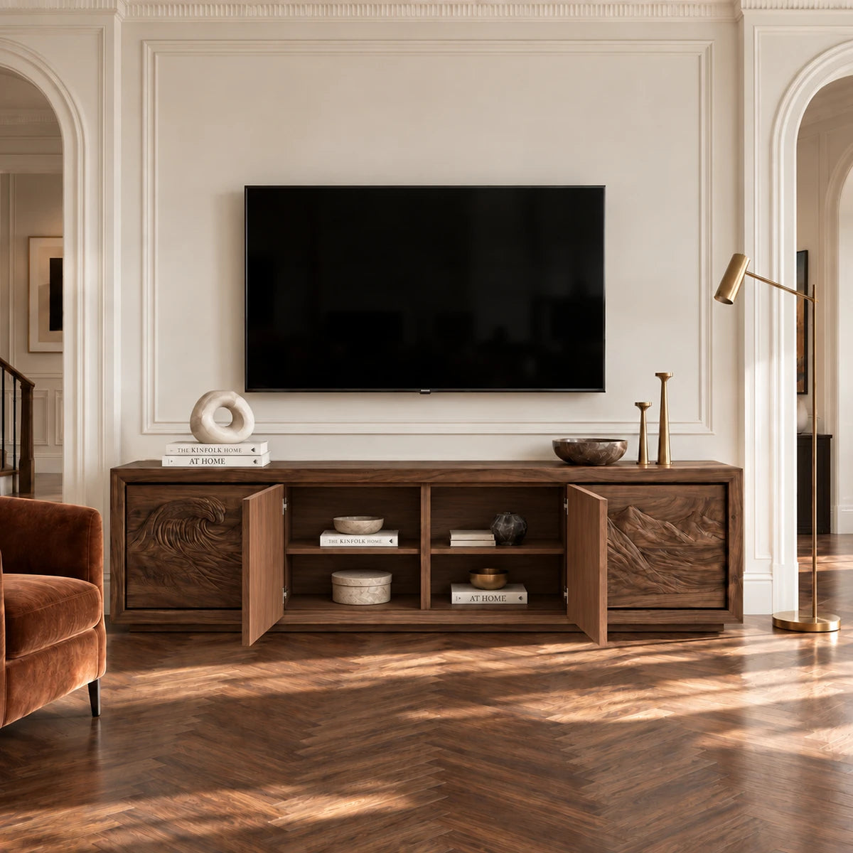 Statement media cabinet in solid wood with carved ocean waves and mountain scenery
