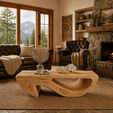 Flowing negative space defines the coffee table with a refined handcrafted furniture look