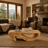 A low profile coffee table with flowing openings brings function to a lodge style room