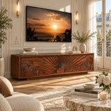 Carved media console with sunburst doors adds sculptural detail beneath a wall mounted TV