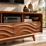 Handcrafted media cabinet with flowing relief doors and spacious open storage above
