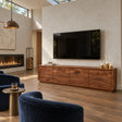 Sculpted solid wood TV stand with wave-front doors and a sleek low-profile form
