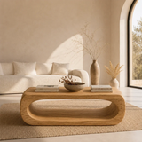 Statement coffee table with smooth curves and monolithic wood form for luxury living rooms