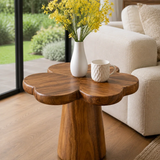 Accent end table featuring a flower shaped top and tapered pedestal base indoors