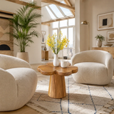 Statement end table with clover inspired top in a calm contemporary living room space