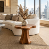 Curved side table adds sculptural character and practical surface to serene interiors