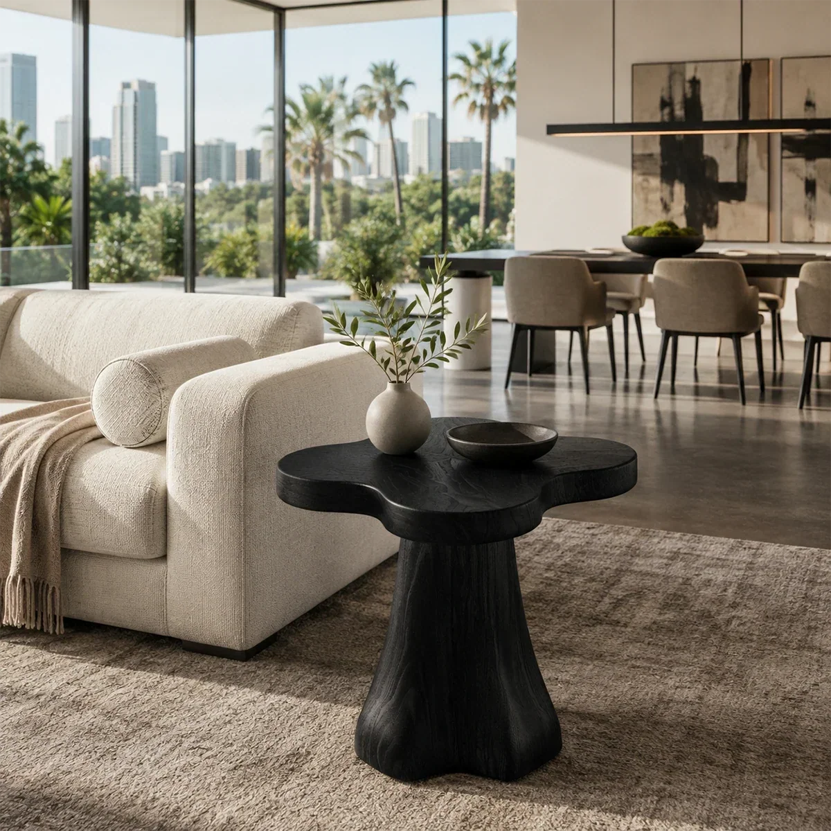 Luxury side table with rounded organic top and sculpted support in a bright interior