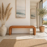 Entryway bench with sculpted solid wood sides and warm natural finish in an airy home