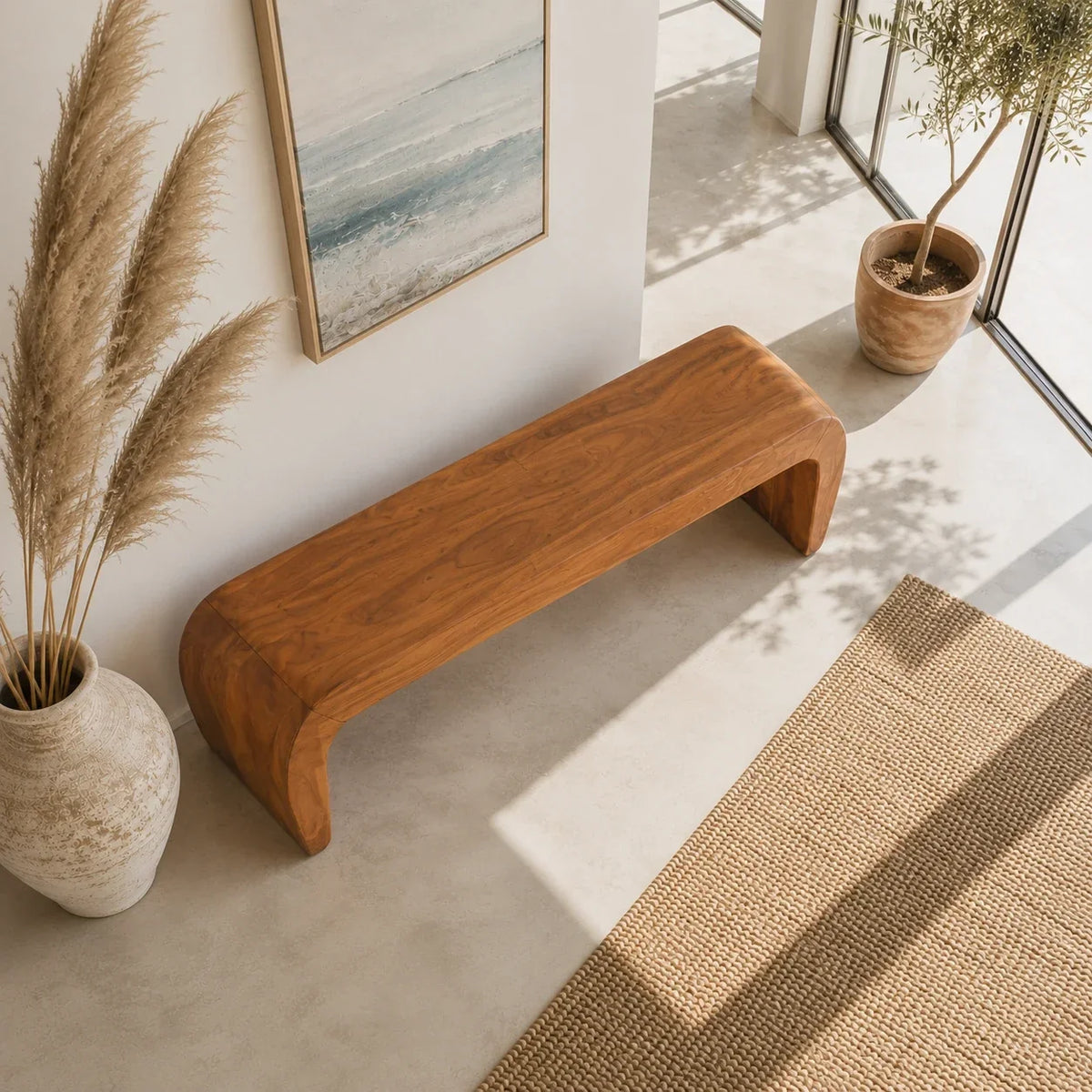 Minimalist bench with broad seat and curved solid wood supports in a serene interior