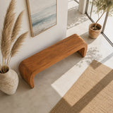 Minimalist bench with broad seat and curved solid wood supports in a serene interior