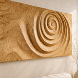 A large abstract wall sculpture brings sweeping spiral texture to a spacious living area