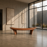 Modern wood bench with elevated ends and smooth solid wood form in a gallery setting