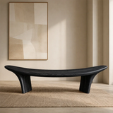 Contemporary bench with fluid seat contour and sculptural wood supports for modern rooms