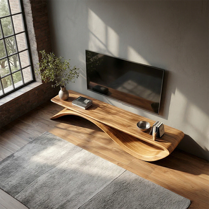Sculptural TV console with curved base and natural wood appearance in minimalist setting