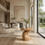 Statement end table with flowing lines and visible grain in a minimalist home setting