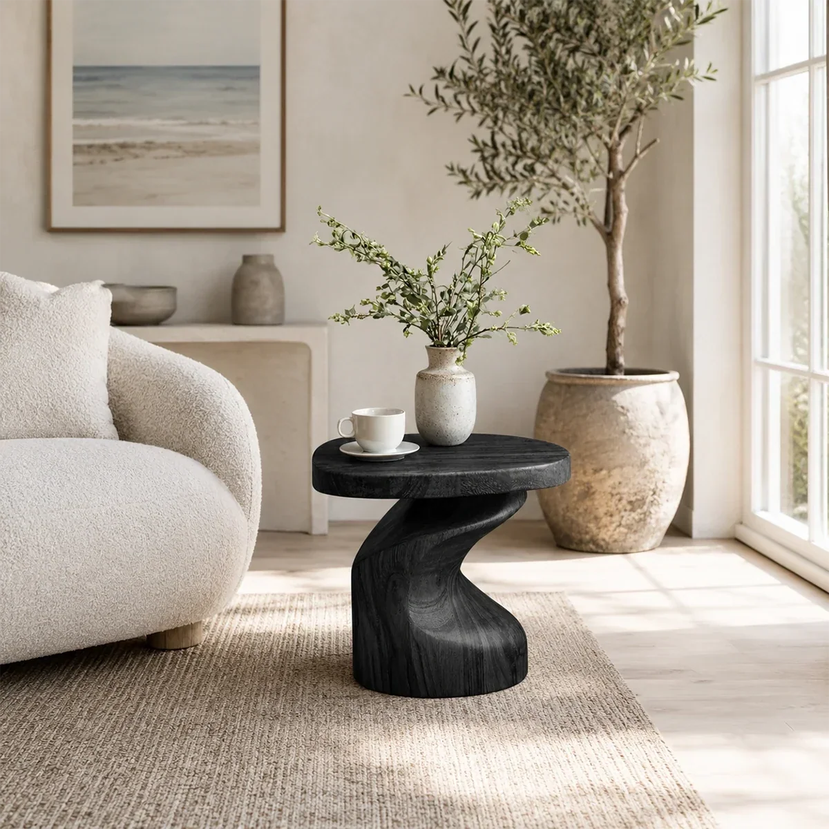 Luxury side table with a sculpted pedestal base and rounded top in a bright interior