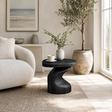 Luxury side table with a sculpted pedestal base and rounded top in a bright interior