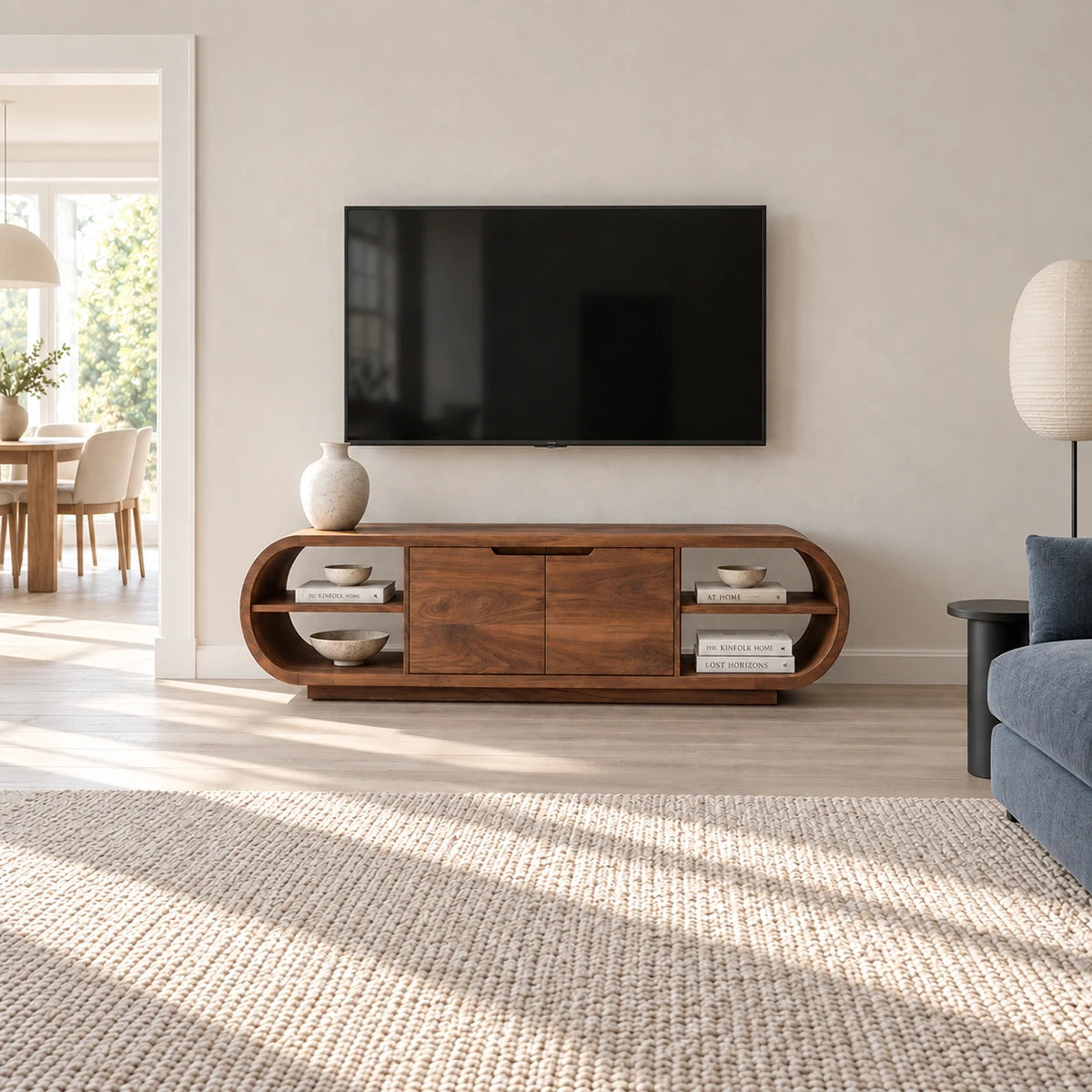 Architectural television console in solid wood with soft curves and hidden storage
