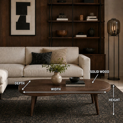 Organic shape coffee table with rounded edges and tapered legs in a modern living space