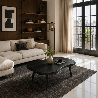 Living room coffee table with smooth contours and handcrafted legs in an urban interior