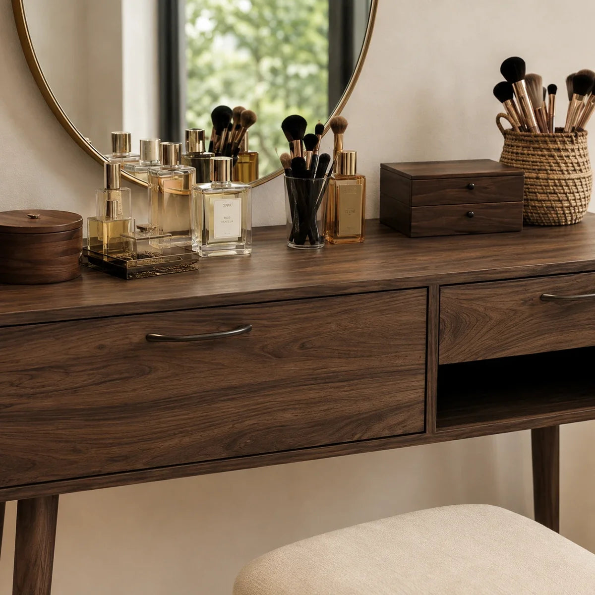 Cosmetic vanity table with tapered legs and dark wood tone finish in a bright bedroom