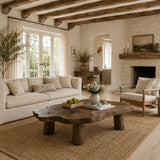 Organic coffee table with thick freeform top and sturdy legs for a warm rustic living room