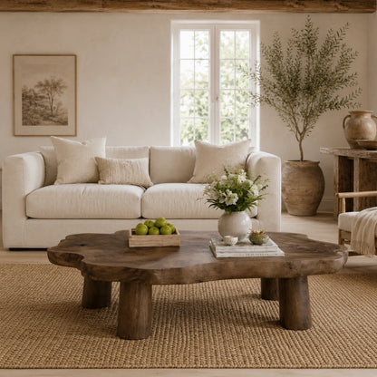 Rustic coffee table with broad organic top and chunky legs for a modern farmhouse room